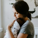 mother carrying baby