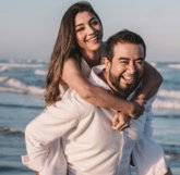 man in white dress shirt hugging woman in white dress
