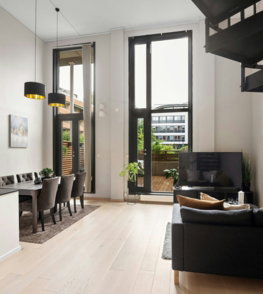 A living room filled with furniture and a staircase